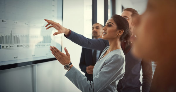 Businesswoman pointing with colleagues